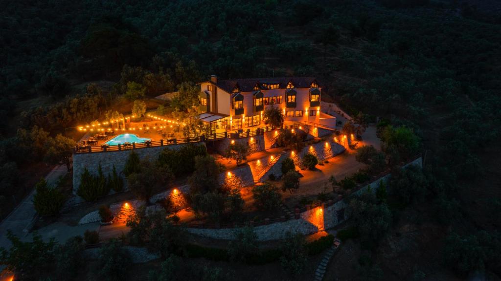 an aerial view of a mansion at night with lights at KAZDAĞLARI ZEYTUNİHAN BUTİK OTEL in Edremit