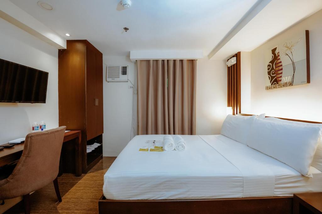Postel nebo postele na pokoji v ubytování Emerald Boutique Hotel