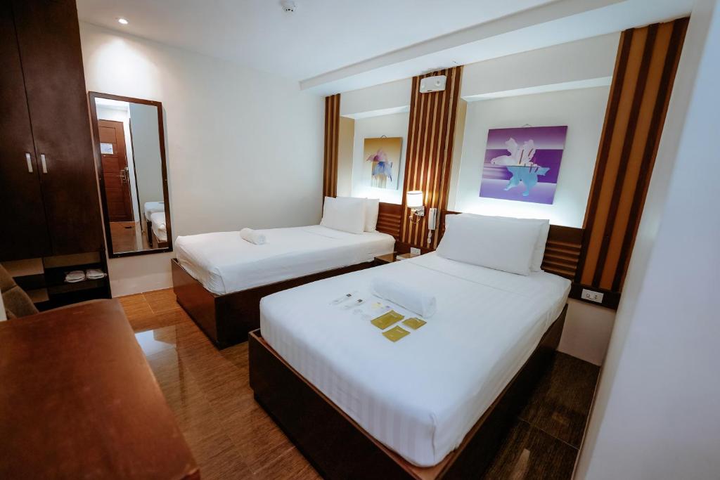 Postel nebo postele na pokoji v ubytování Emerald Boutique Hotel