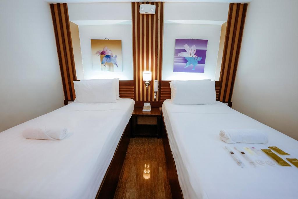 Postel nebo postele na pokoji v ubytování Emerald Boutique Hotel
