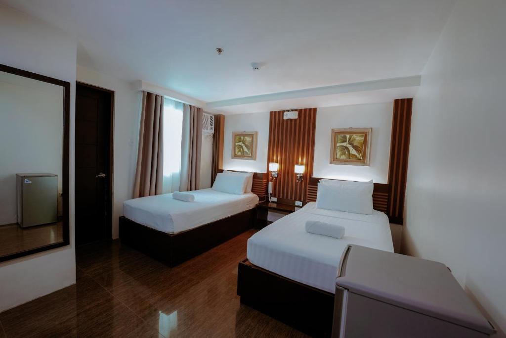 Postel nebo postele na pokoji v ubytování Emerald Boutique Hotel