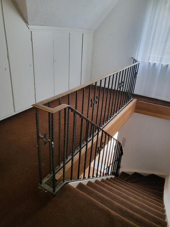 a spiral staircase in a building with a railing at Monteurunterkunft Licherode 