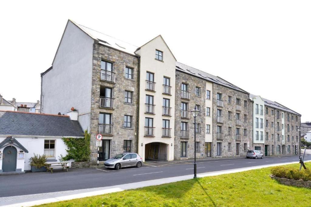 a building with a car parked in front of it at 2 Bed Gated Apartment Westport in Westport