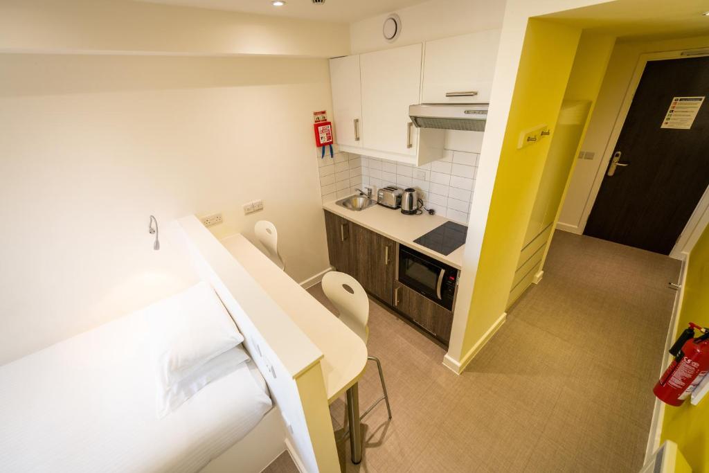 a small room with a kitchen and a bed at University of Bath City Accommodation in Bath