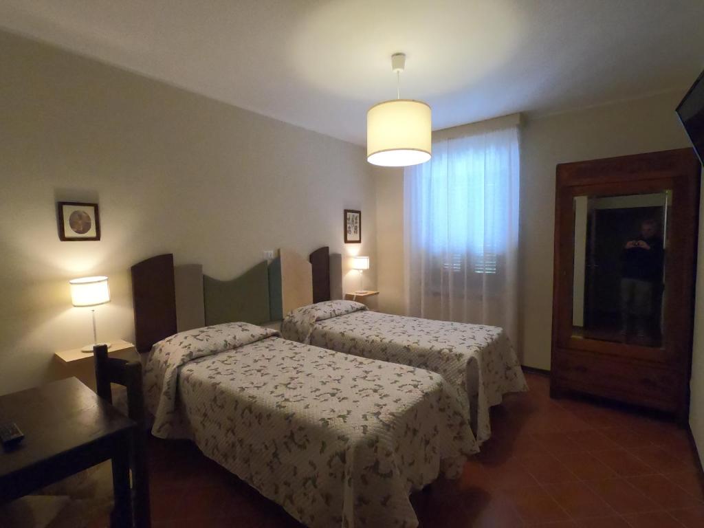 Postel nebo postele na pokoji v ubytování La Locanda del Collaccio