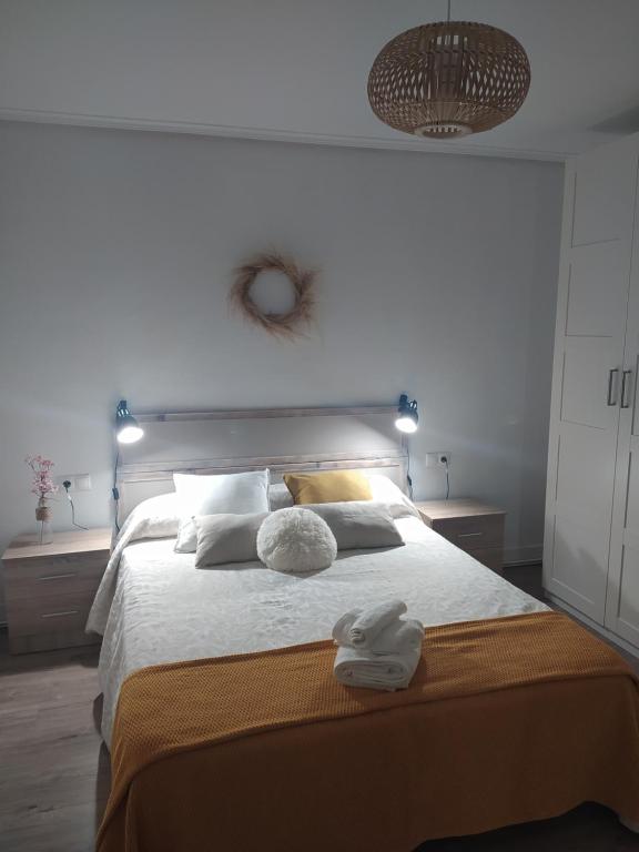 a bedroom with a large bed with two towels on it at Apartamento Beretaberri in Narvarte