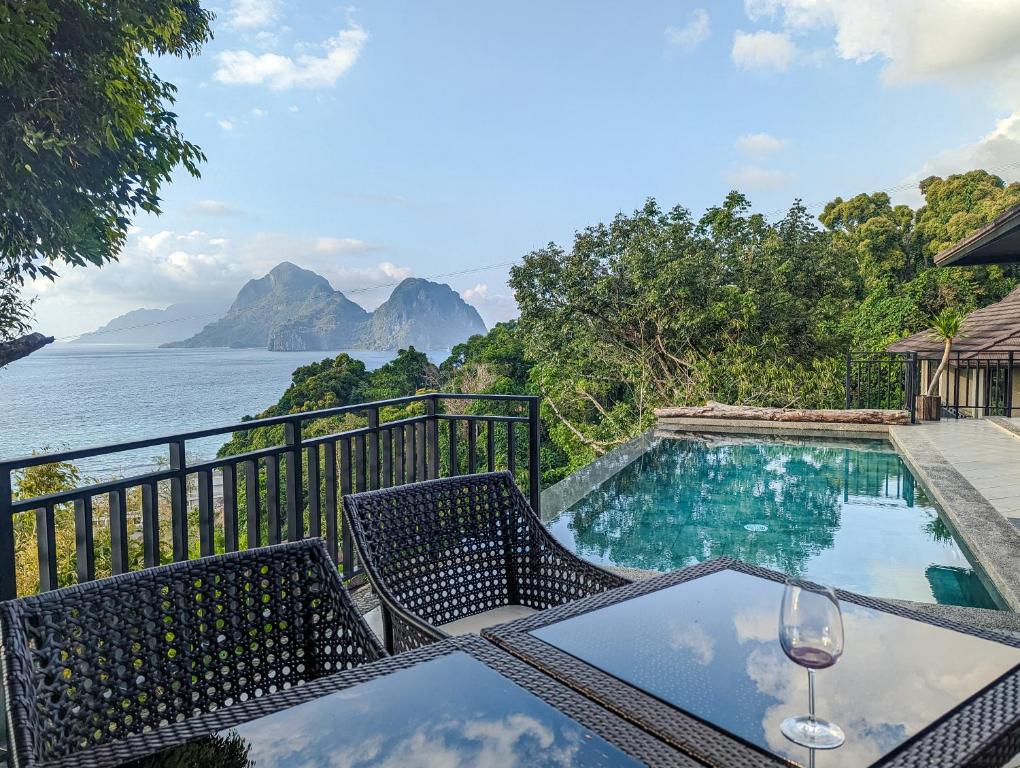 a table and chairs with a view of the ocean at Perch El Nido's Seaview Villas Maremegmeg in El Nido
