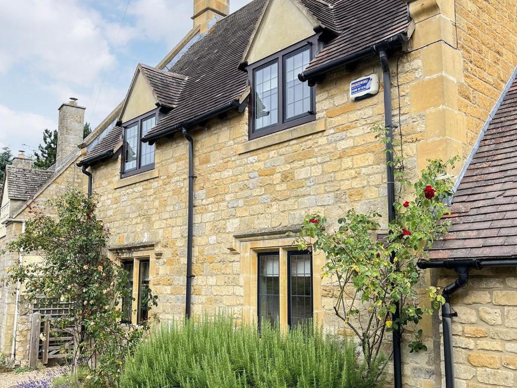 an old brick house with windows and a roof at Lavender Cottage in Stretton on Fosse