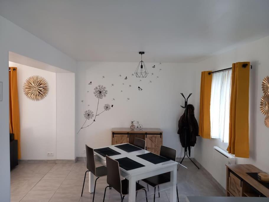 a dining room with a white table and chairs at Le Watt'else in Watten