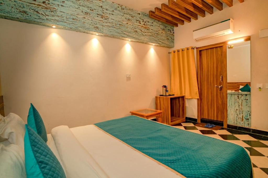 Ostel By Orion Hotels -Udaipur في أودايبور: غرفة نوم بسرير في غرفة