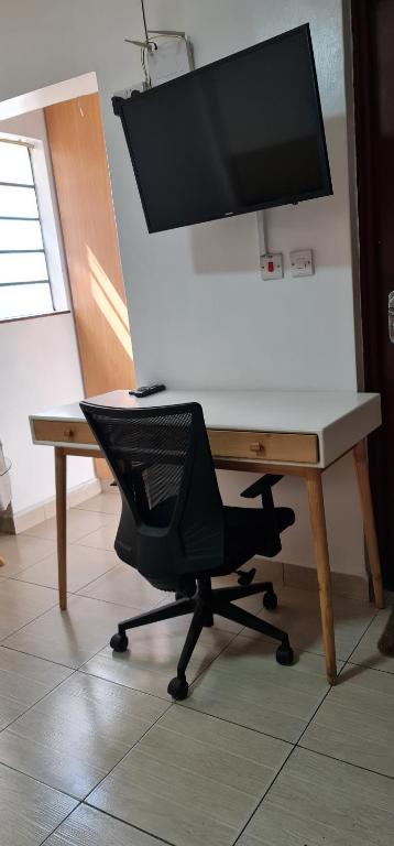 a desk with a computer monitor on top of it at Eagle nest 2 in Nairobi