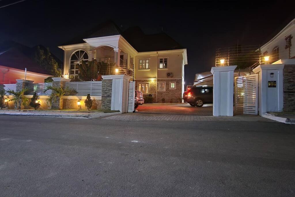 a house with a car parked in front of it at night at Captain's Residence in Abuja