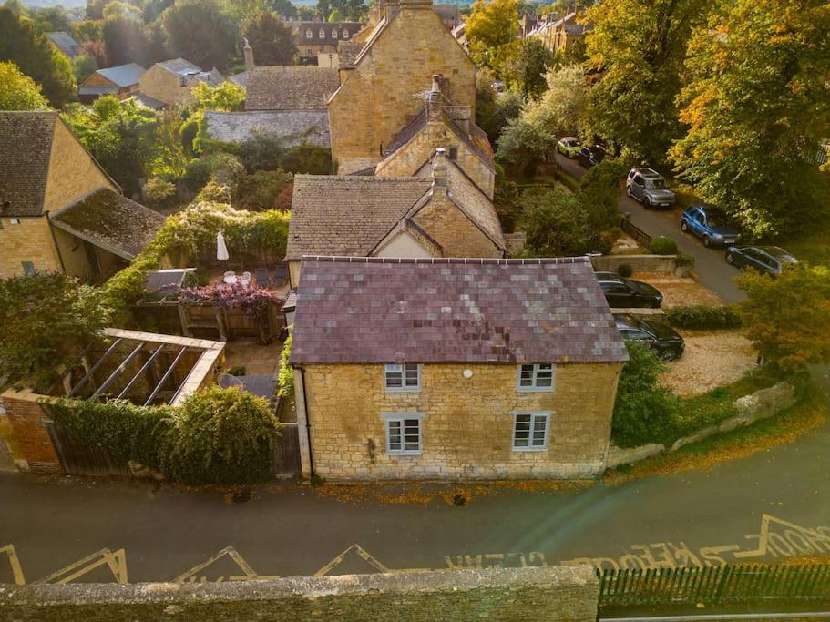 an aerial view of an old house in the water at Cotswolds Corner Cottage in Moreton in Marsh