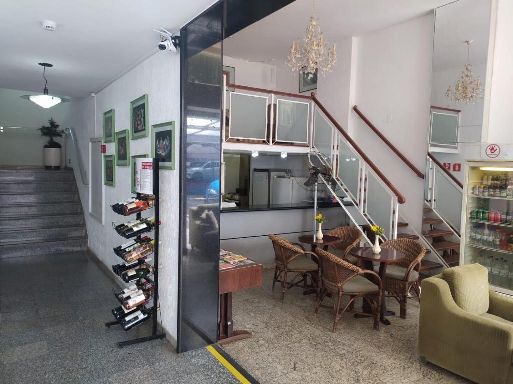 a room with a staircase and a dining room with a table at Dublin Hotel in São Paulo