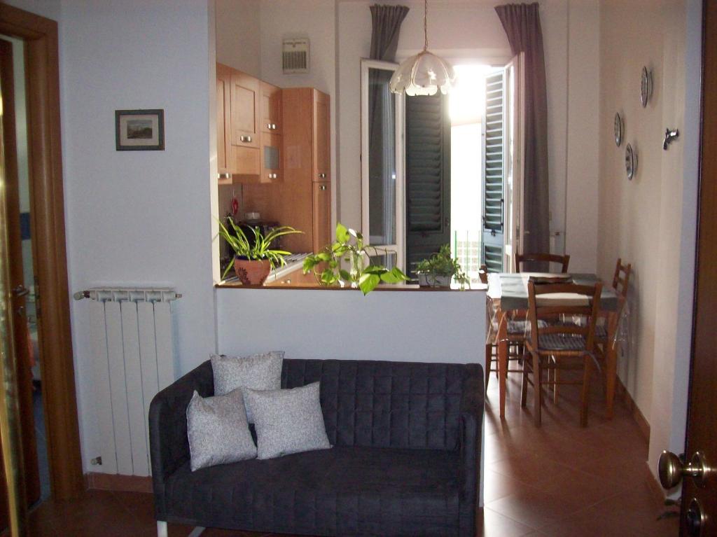 a living room with a couch and a dining room at Casa Mia in Florence