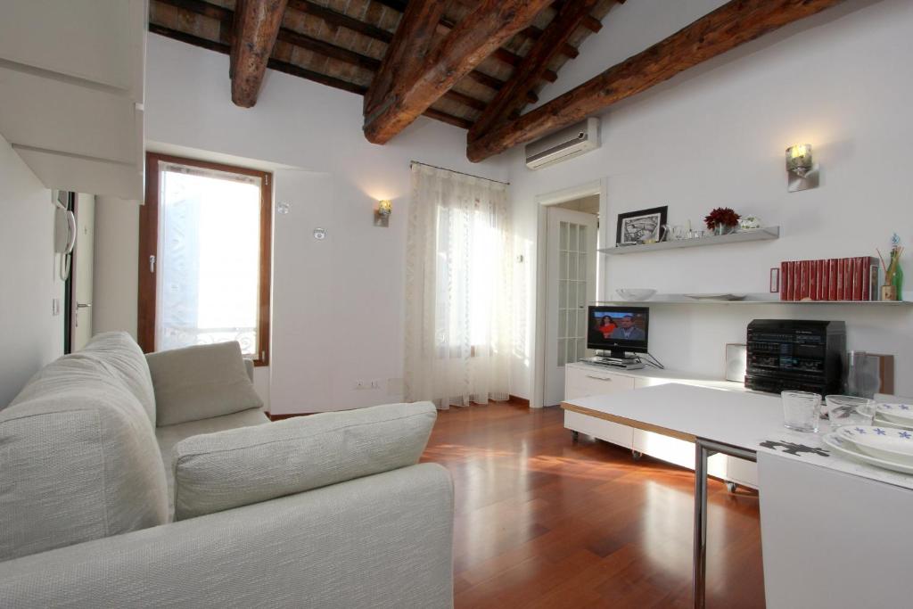 a living room with a white couch and a table at City Apartments Cannaregio in Venice