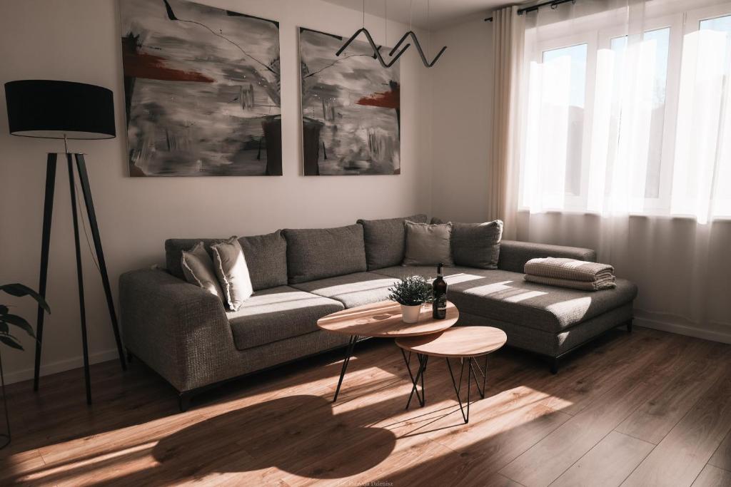 a living room with a couch and a table at Apartament Komfort in Słupsk
