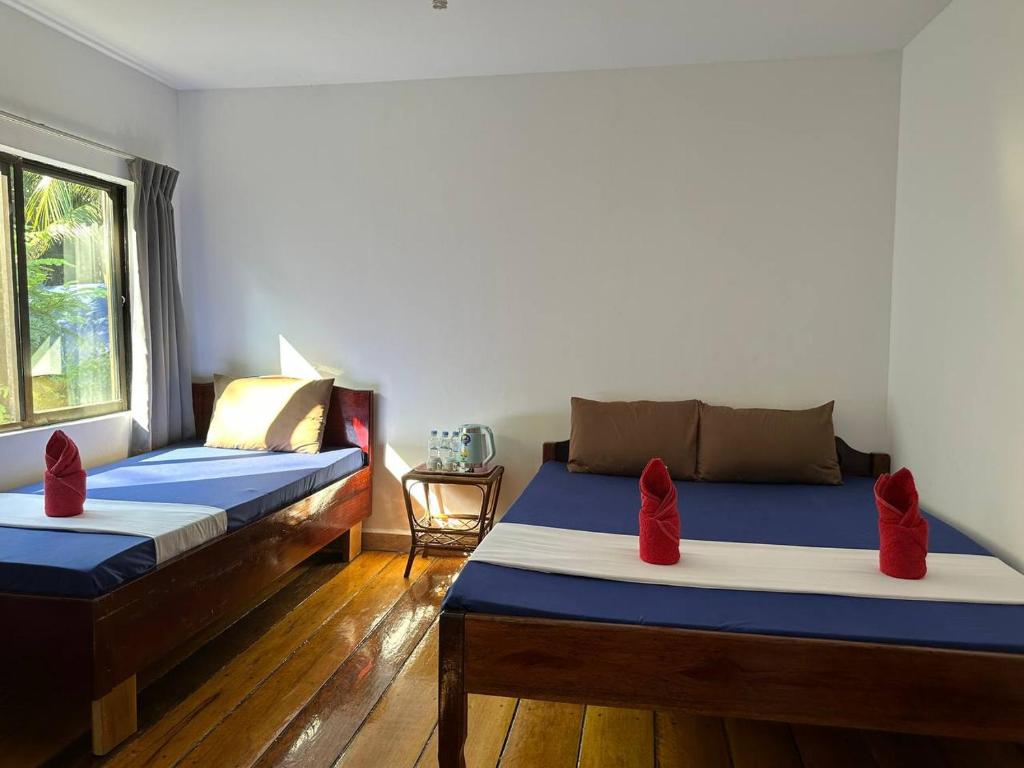 Postel nebo postele na pokoji v ubytování Happy Elephant Bungalows