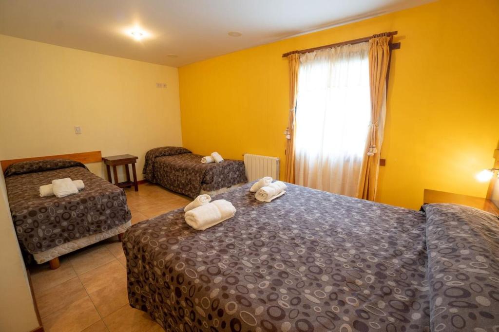 En eller flere senge i et værelse på Hosteria El Paraiso