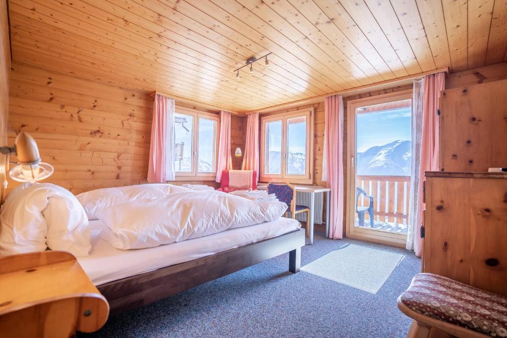 een slaapkamer met een bed in een houten kamer bij Chalet Weisshorn 3 in Bettmeralp