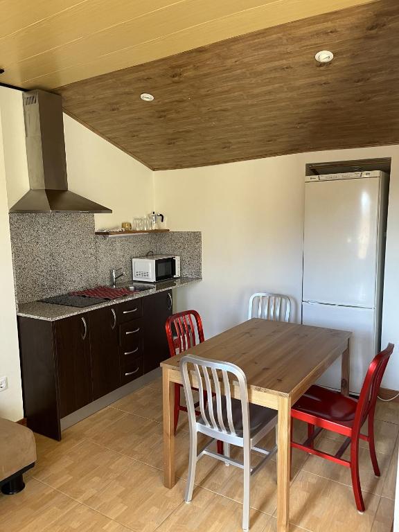 a kitchen with a wooden table and two chairs at El Cerezo in Torre del Compte