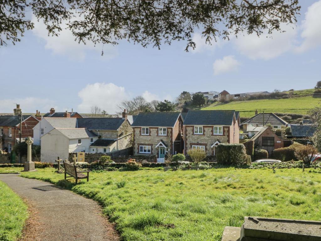 a row of houses in a field with a park at Holly Cottage in Ventnor