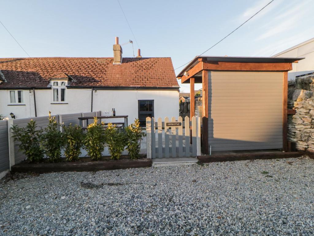 a house with a garage and a fence at Eventide in Plymouth