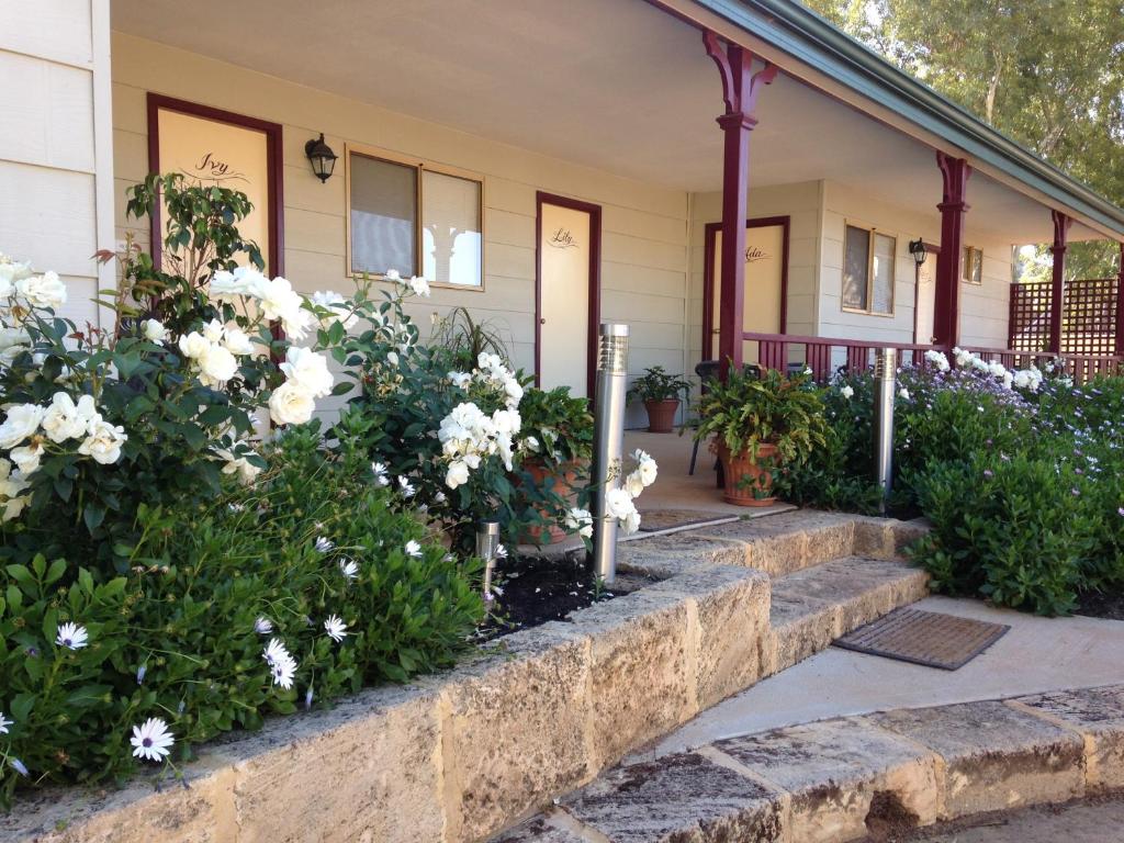 a house with flowers on the front porch at The Nosh & Nod - Avon Terrace in York