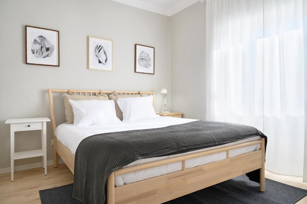 En eller flere senge i et værelse på Sé Apartamentos - BragaXXI