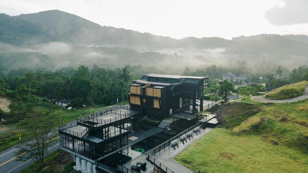 a building on top of a hill with a mountain at D’Endless Resotel in Baen