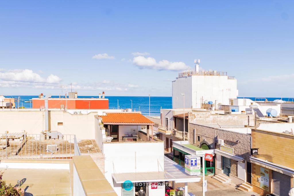 an aerial view of buildings with the ocean in the background at MADREPERLA - SAN FOCA in San Foca