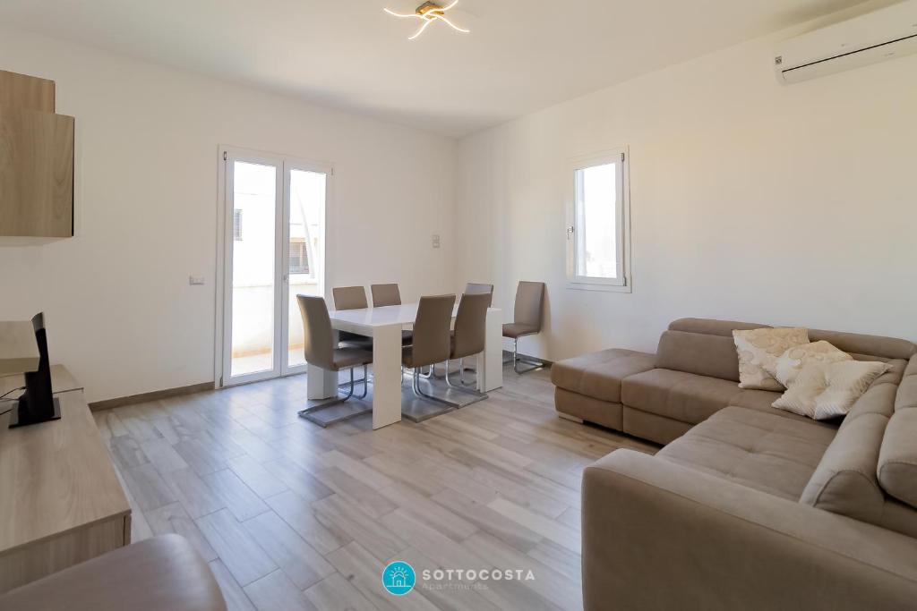 a living room with a couch and a table at MADREPERLA - SAN FOCA in San Foca