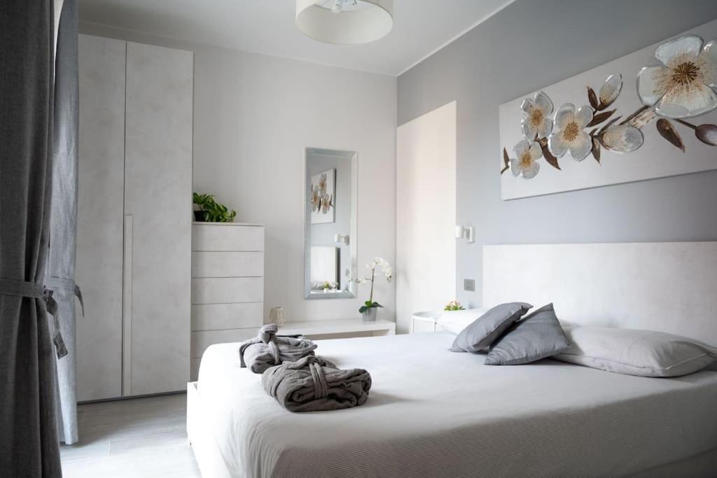 a white bedroom with a large white bed in it at A Casa di Patty 2 in Gorgonzola
