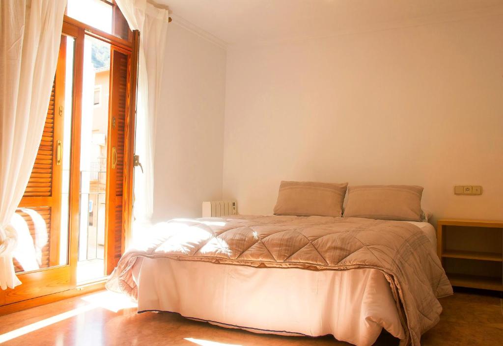 a bedroom with a bed and a large window at N28 in Xàtiva