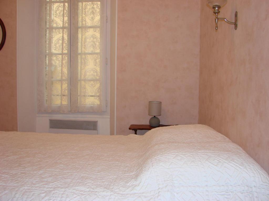 a bedroom with a white bed and a window at ACCI Cannes Old City in Cannes