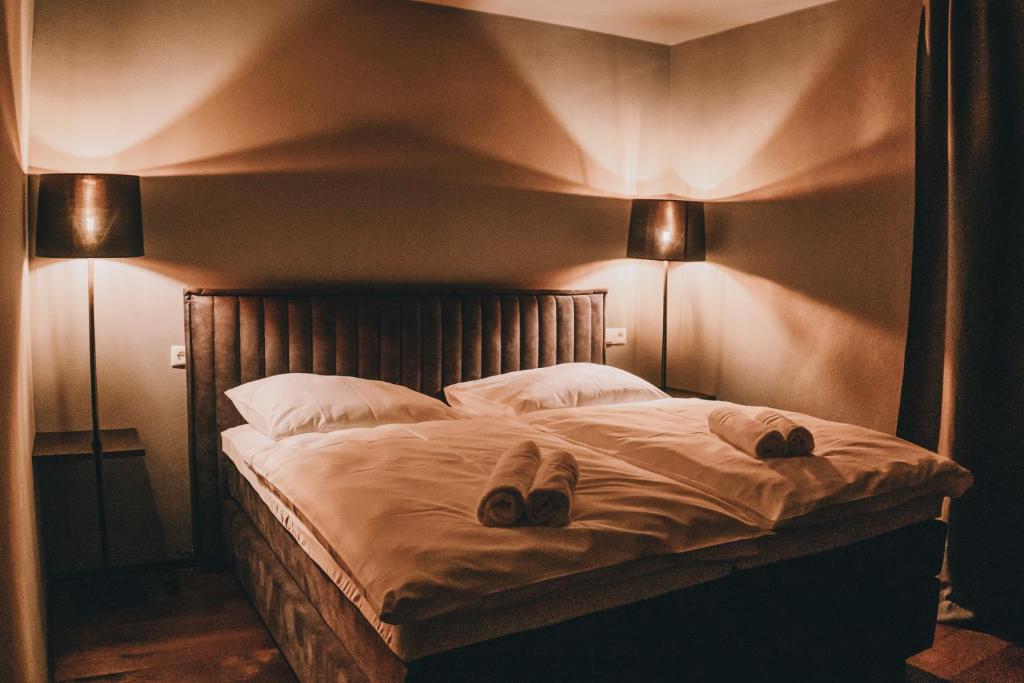 a bedroom with a bed with two towels on it at LA vie Hotel Landshut in Landshut