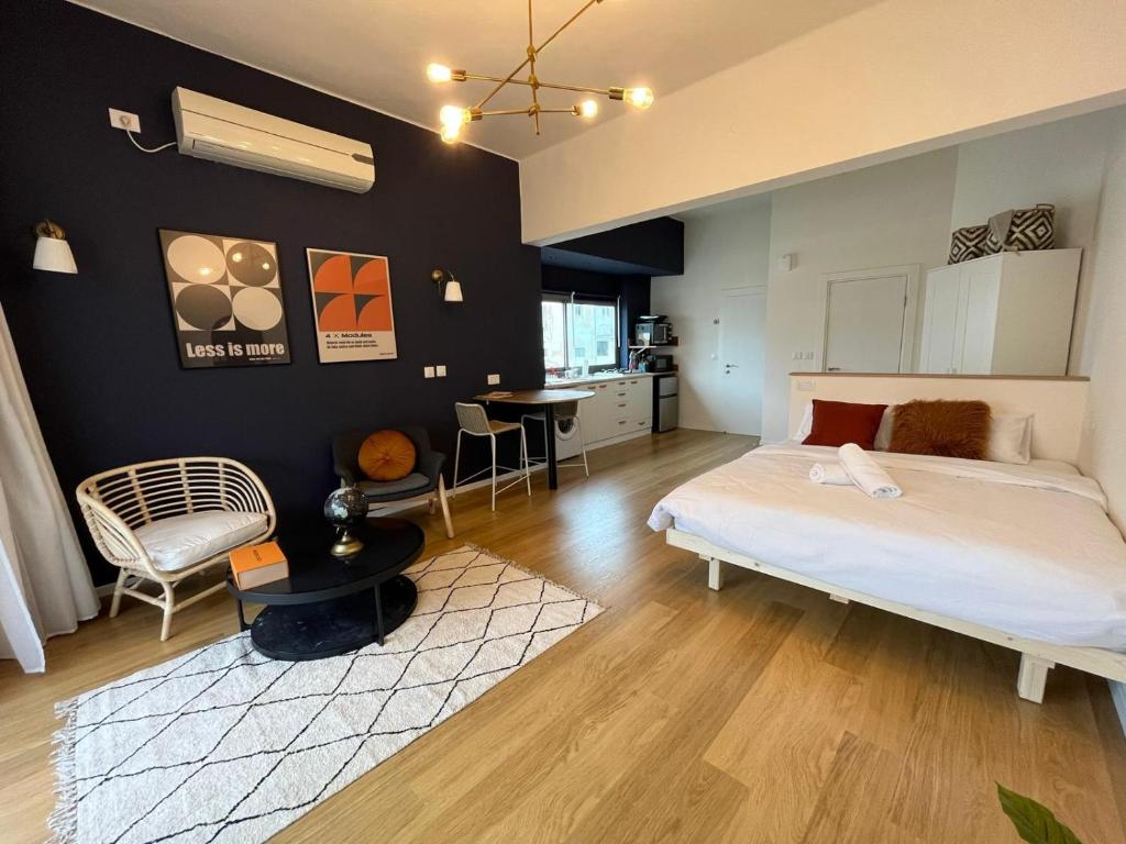a bedroom with a large bed and a kitchen at Loft amazing Grazie Boutique in Tel Aviv