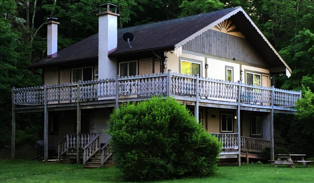 una casa grande con una terraza envolvente en Slide Mountain Forest House, en Oliverea