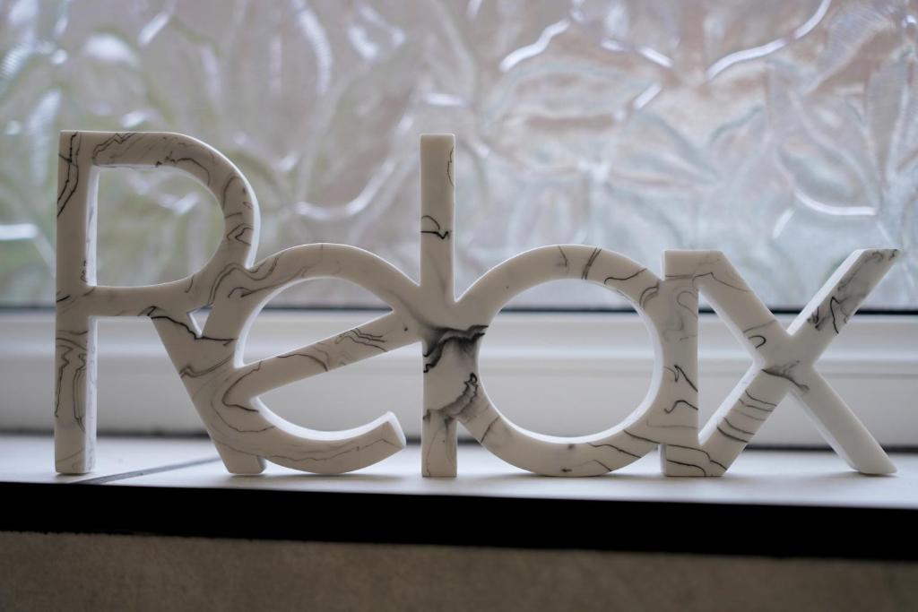 a wooden sign that says hello in front of a window at Redwood in Longton