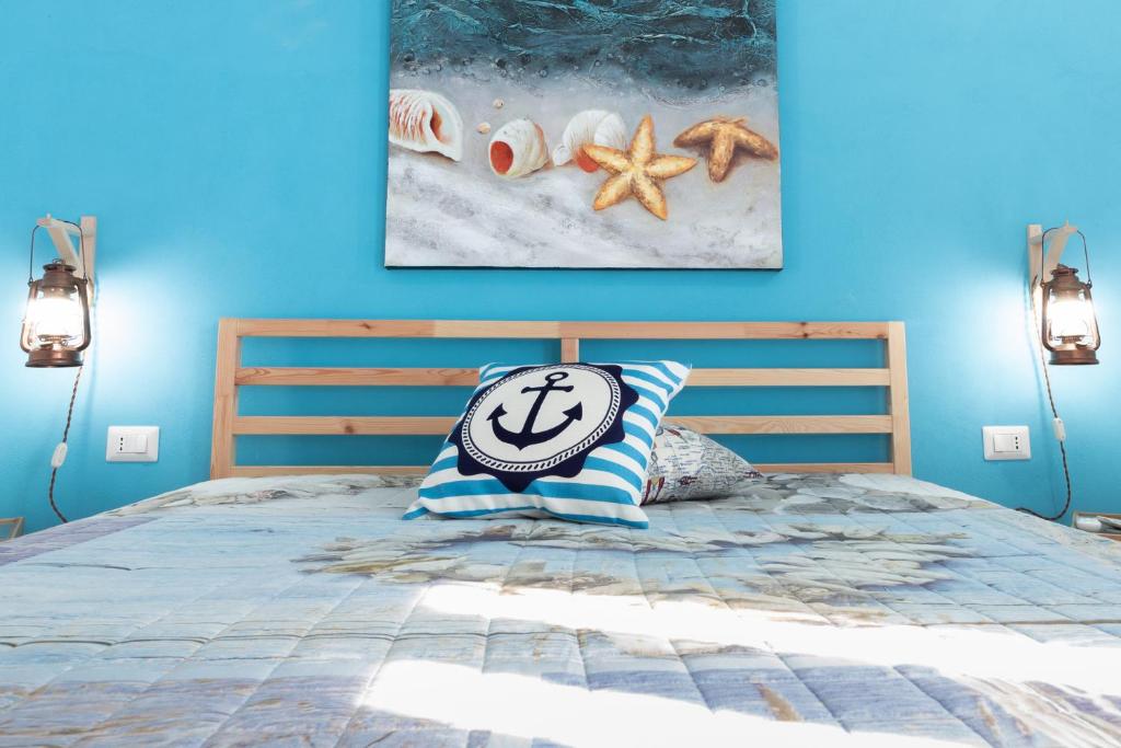 Łóżko lub łóżka w pokoju w obiekcie SyracuseApartments IL PASUBIO di SIRACUSA Stupendo appartamento vicino ad ORTIGIA a 200m dal MARE
