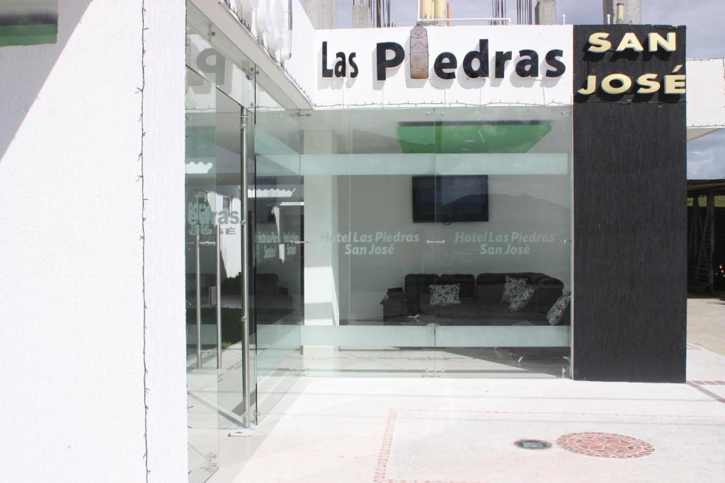 a store window with a sign that reads las paloci san masse at Hotel Las Piedras San Jose in San José de Isnos