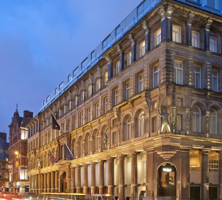 a large building on a city street at night at Hard Days Night Hotel in Liverpool