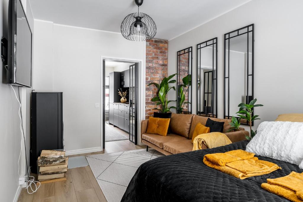 a living room with a bed and a couch at Fabia in Turku