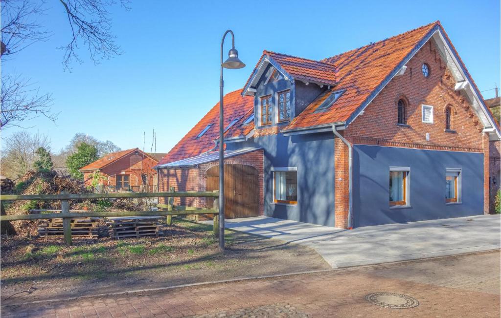a blue house with a red roof at Nice Apartment In Loxstedt With Kitchen in Loxstedt