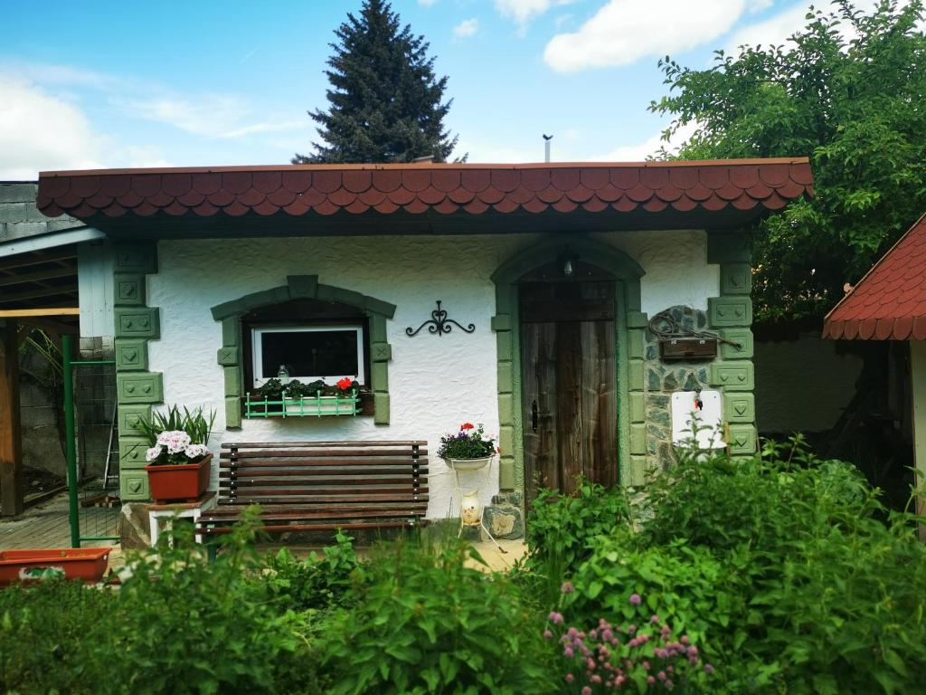 a small house with a porch and a window at Perníková chalúpka in Bojnice