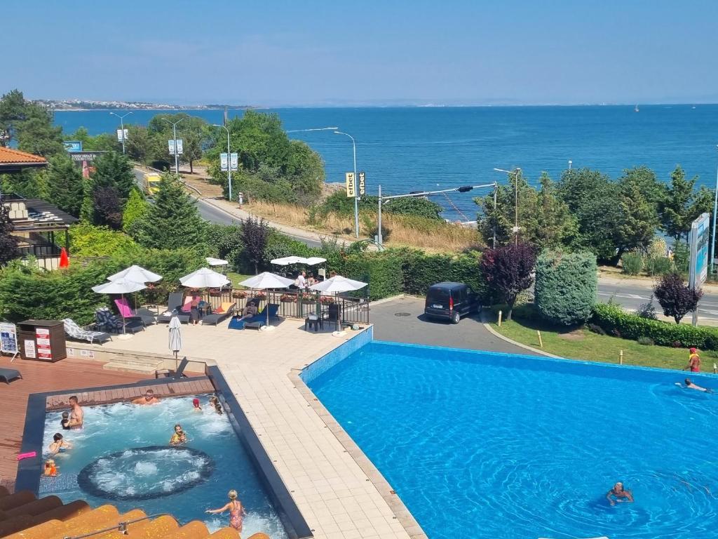 a pool at a resort with a view of the ocean at Eve Santa Marina Apartment II - sea, pools, relax in Sozopol