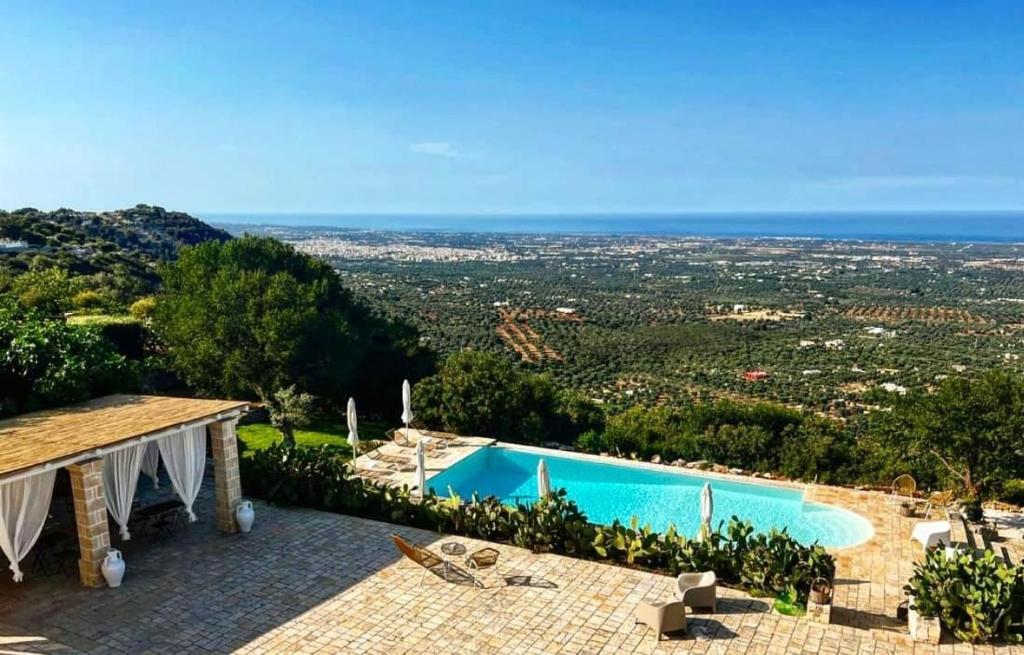 a villa with a swimming pool and a view at Dimora Le Ginestre in Fasano