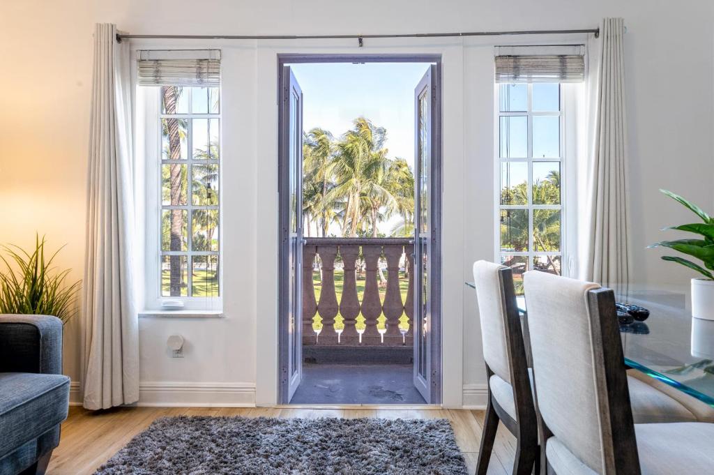 a living room with a door leading to a balcony at Meet Me On Ocean Dr - Cozy Stay Steps From Beach in Miami Beach