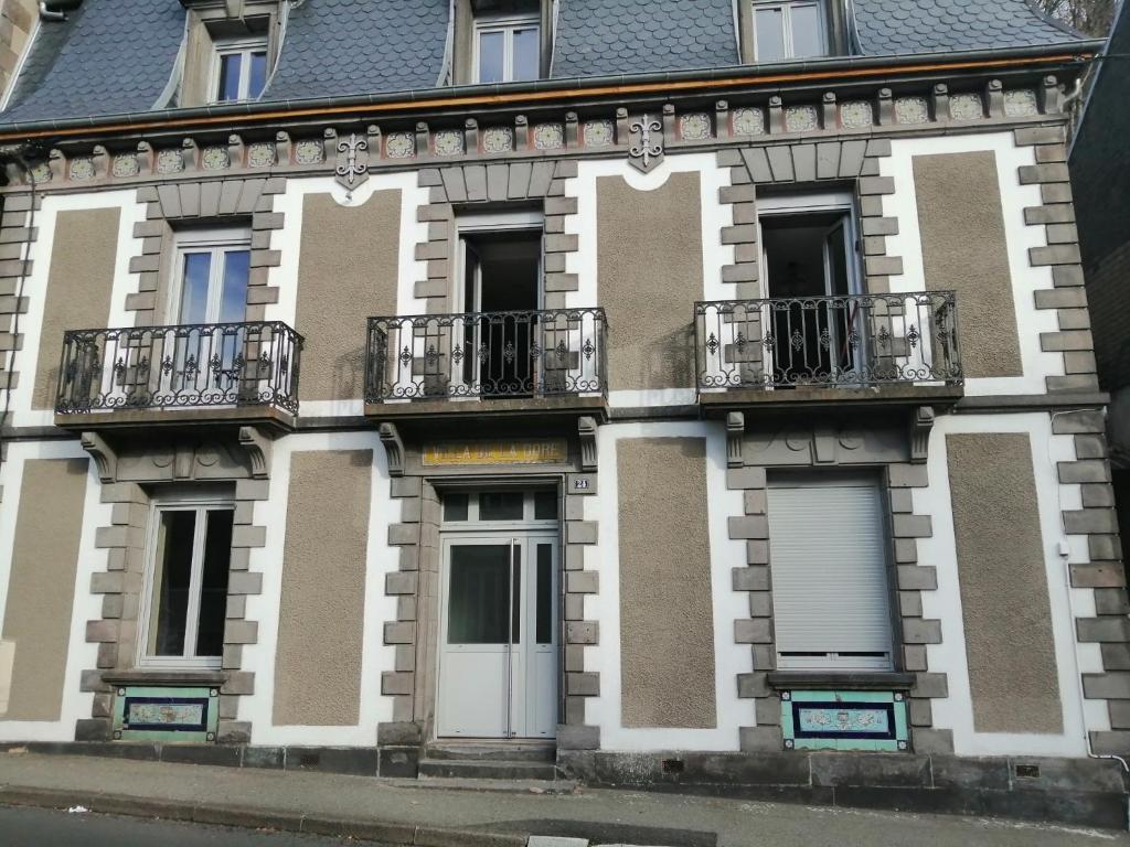 a building with balconies on the side of it at Villa de la dore in Le Mont-Dore