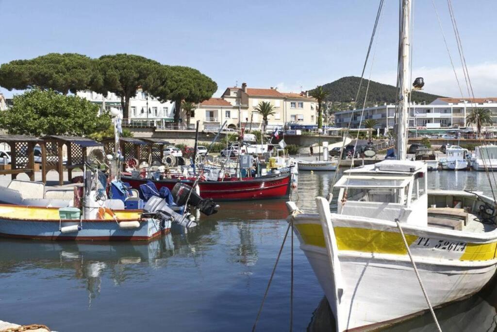 a group of boats are docked in a harbor at Les Jardins de Provence • Beau Rivage • Proche mer in Carqueiranne